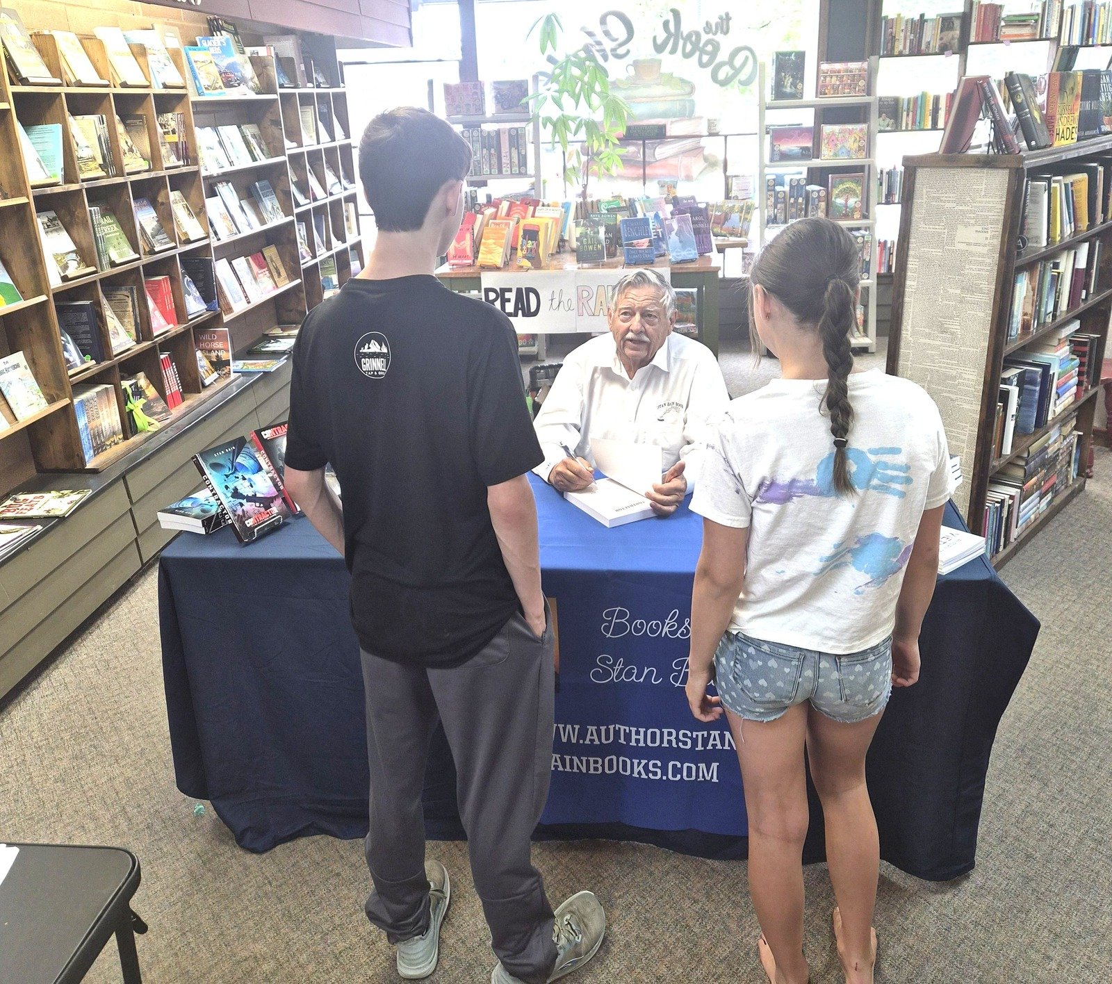 Author Stan Bain signing books at The Bookshelf in Kalispell, Montana