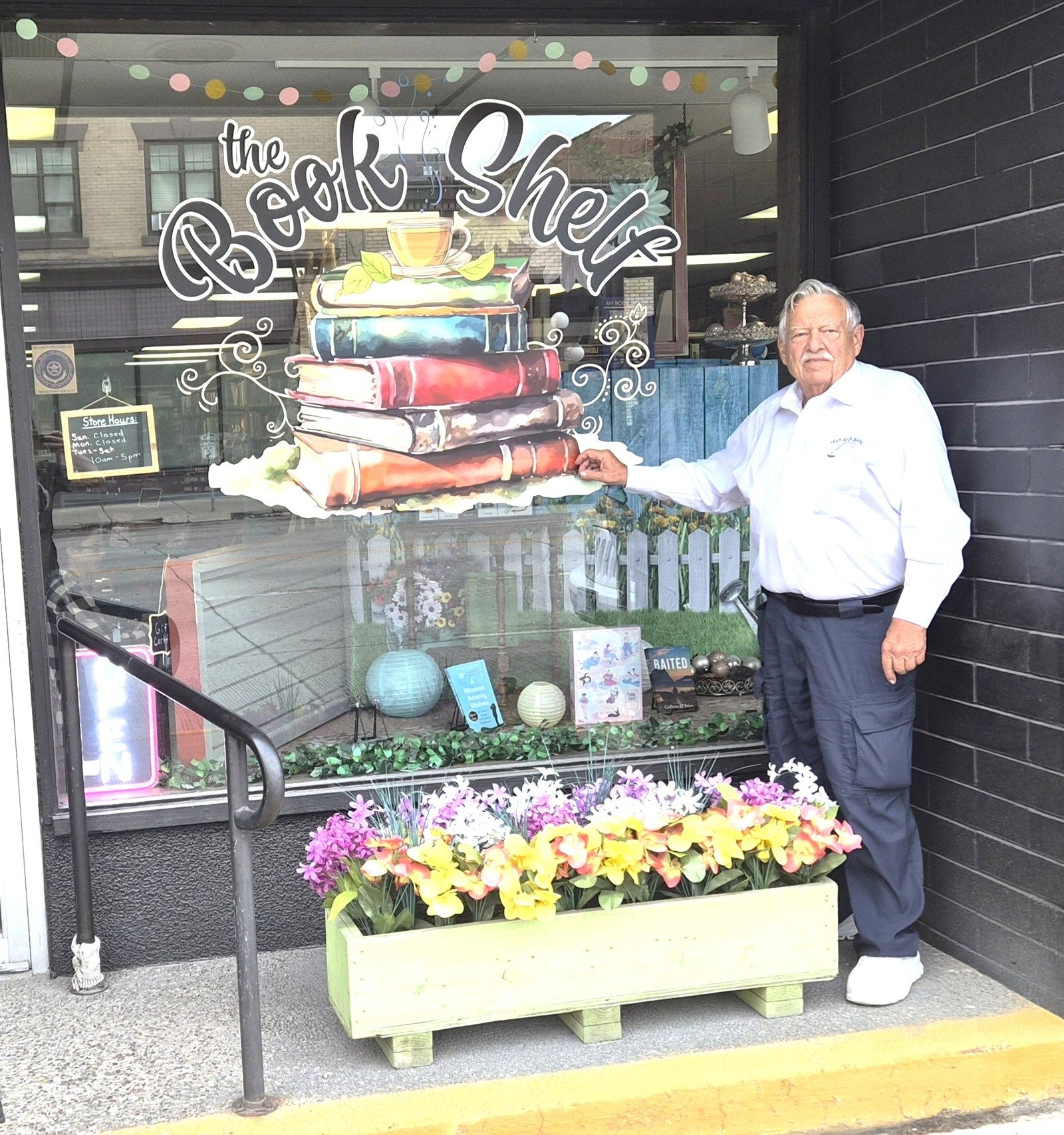 Stan Bain outside The Bookshelf storefront